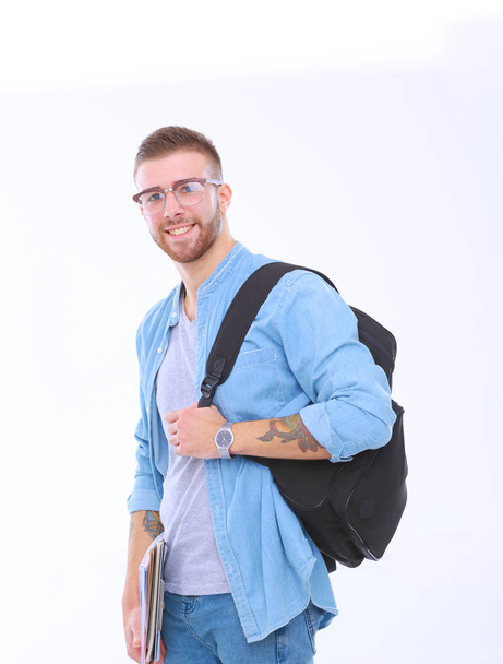 A male student with a school bag holding books isolated on white background. Education opportunities. College student. - Fotó, kép