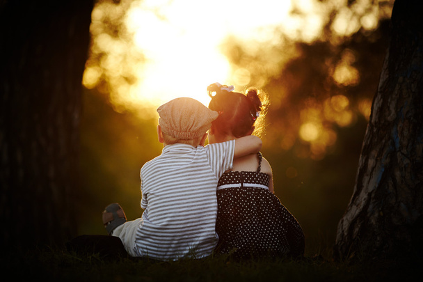 boy and girl on sunset - Фото, зображення