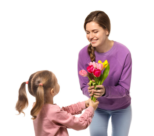 little girl giving mother flowers - Fotó, kép