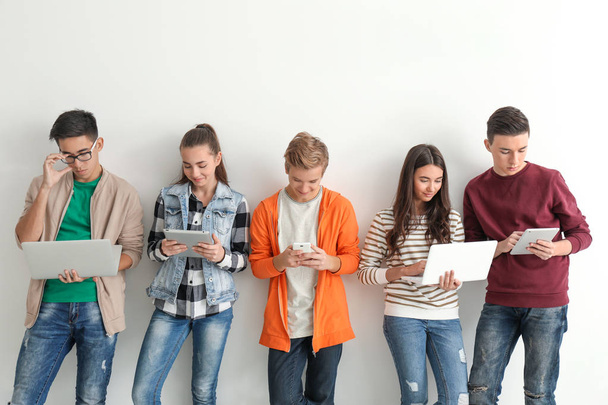 Group of teenagers with modern devices - Foto, imagen