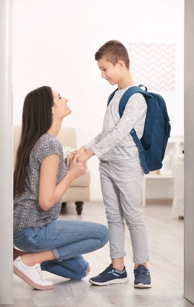 Young woman saying goodbye to her son before school - Foto, Imagen