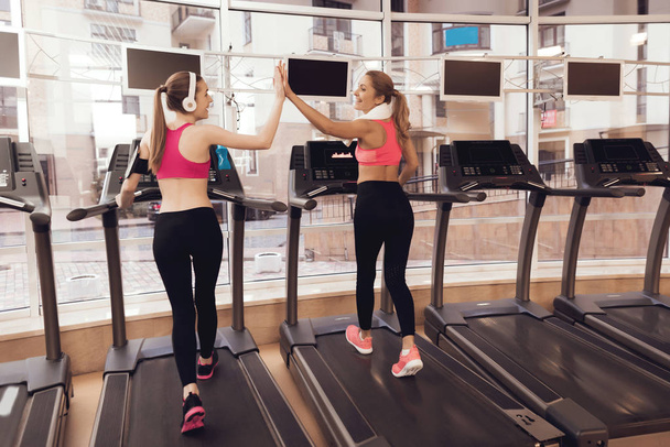 Women in sportswear running on treadmill at gym - Фото, зображення