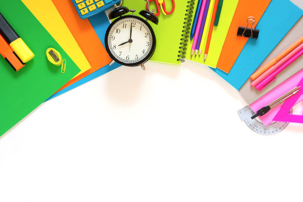 Colorful school supplies, book, and alarm clock on white. Top view, flat lay. Copy space. - Photo, Image