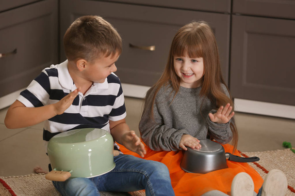 little musicians playing drums on kitchenware - Foto, Imagen