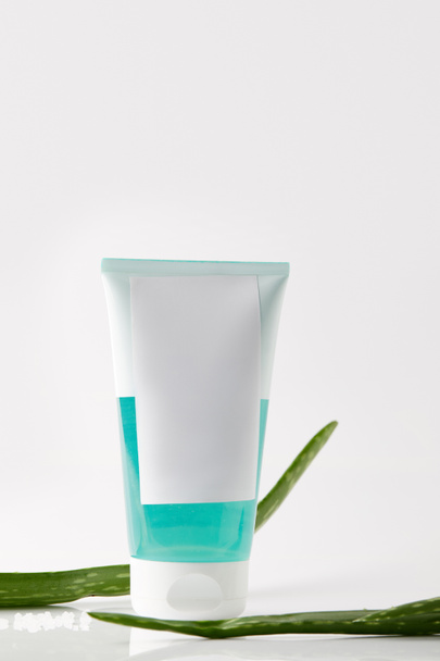 closeup view of cream tube and aloe vera leaves isolated on white background  - Photo, Image