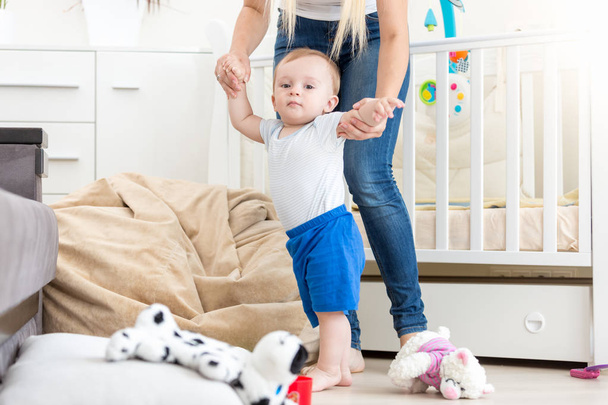 10 months old toddler boy learning making first steps with mother - Φωτογραφία, εικόνα