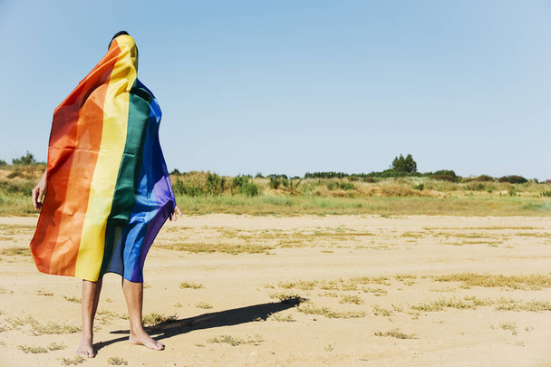 uomo coperto con una bandiera arcobaleno
 - Foto, immagini