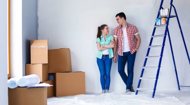 Portrait of young couple moving in new home. Young couple - 写真・画像