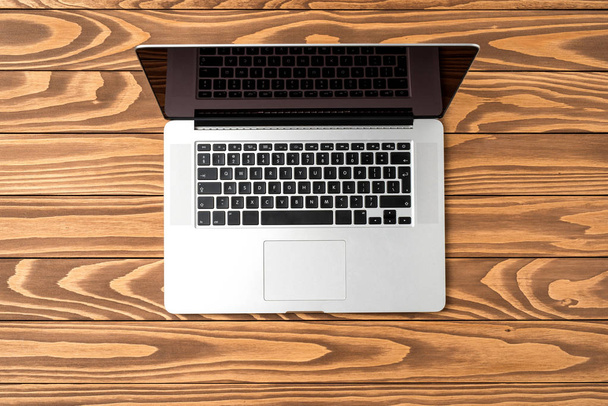 Modern laptop on wooden table. Close up - Фото, зображення
