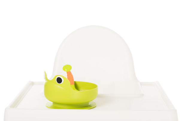 plate in form of frog with baby food on highchair isolated on white background  - Fotó, kép