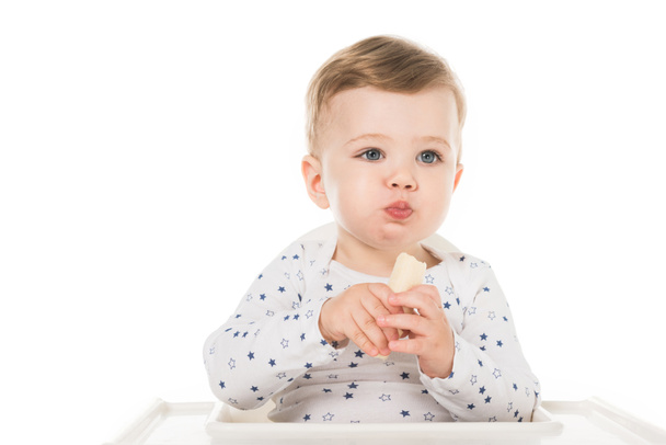 adorable little boy eating banana isolated on white background  - Foto, Imagen