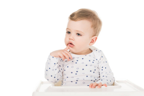 little boy sitting in highchair isolated on white background  - Foto, Imagem
