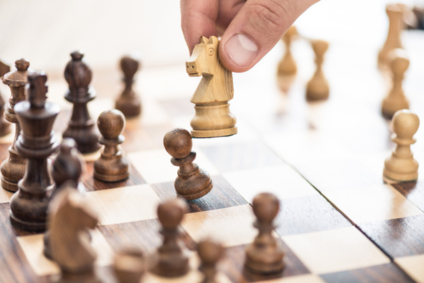 cropped shot of human hand playing chess, selective focus - Foto, immagini