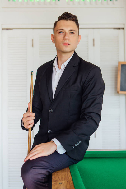 Young handsome man playing billiard game alone - Фото, изображение