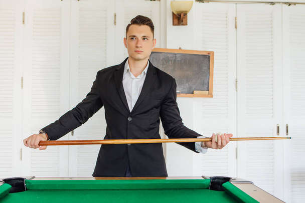 Young handsome man playing billiard game alone - Photo, image