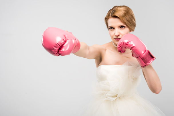 strong bride in wedding dress and boxing gloves, isolated on grey, feminism concept - Photo, Image