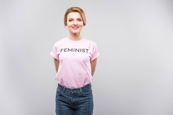 smiling woman in pink feminist t-shirt, isolated on grey - Fotoğraf, Görsel