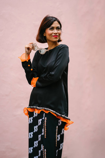 Fashion portrait of a beautiful, asian fashionable woman  posing on the street - Photo, Image