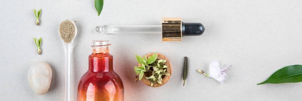 Minimal style. Natural cosmetics, handmade skin and body care. Orange bottle with peep and plants. Flat lay - Photo, Image