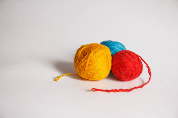 three colored balls of thread on white background - Zdjęcie, obraz