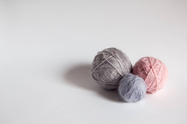 three colored balls of thread on white background - Фото, изображение