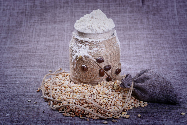 A decorative container of flour is in the grain - Photo, Image