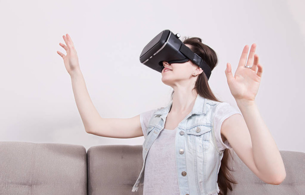 beautiful woman playing game in virtual reality glasses. - 写真・画像