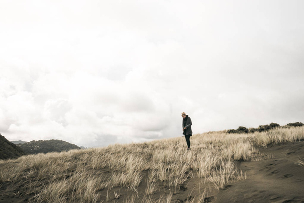 Young woman walking by Mount Aspiring national park. - Фото, изображение
