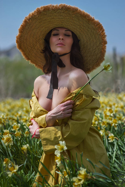 photo of a beautiful girl on a background of flowers - Foto, afbeelding