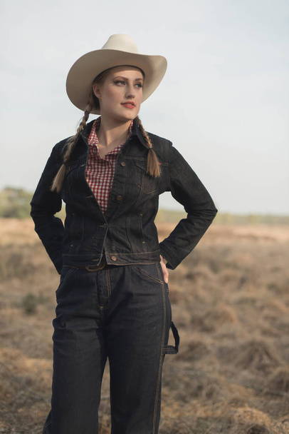 Retro cowgirl in countryside - Photo, image