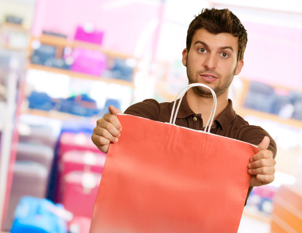 Young Man Holding Shopping Bag - Fotoğraf, Görsel