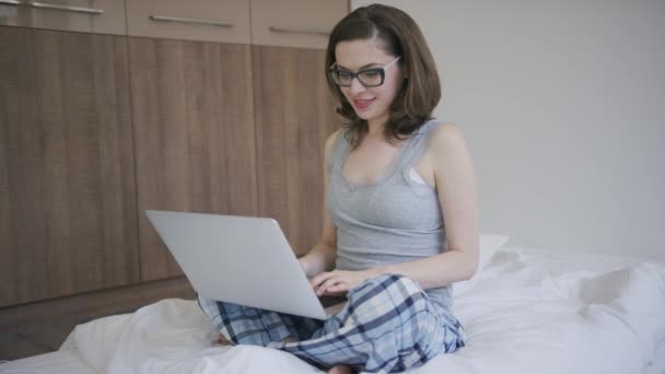Woman in glasses using laptop - Felvétel, videó