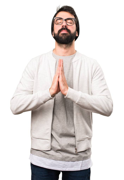 Hipster man in zen position on white background - Foto, afbeelding