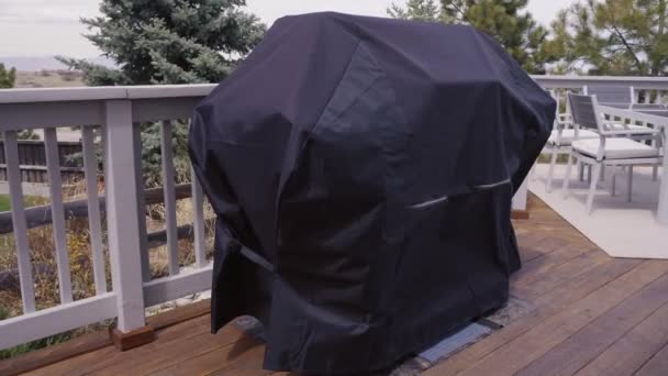 Grill gazowy duże pokryte czarną pokrywę do ochrony z elementów – Pogoda - Materiał filmowy, wideo