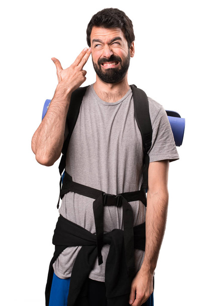 Handsome backpacker making suicide gesture on white background - Photo, Image