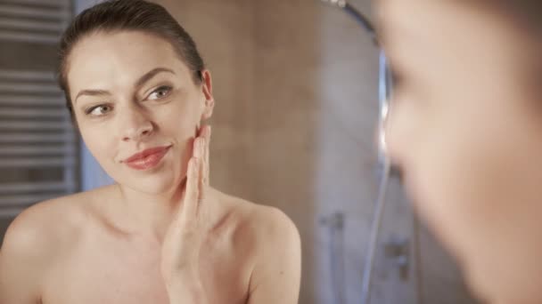 Woman applying foundation near mirror - Footage, Video