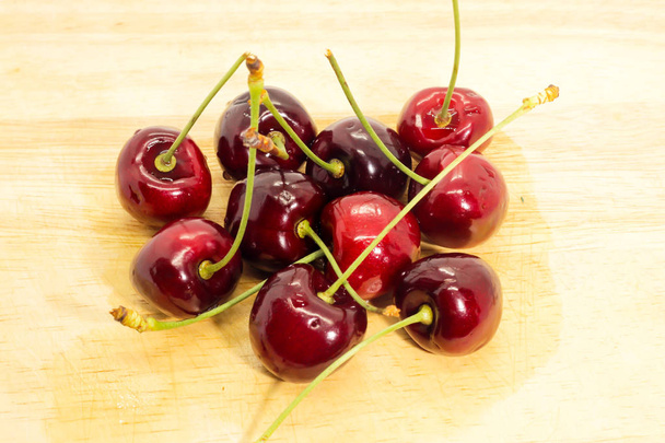 Closeup of group Fresh cherry on brown wooden - Photo, Image