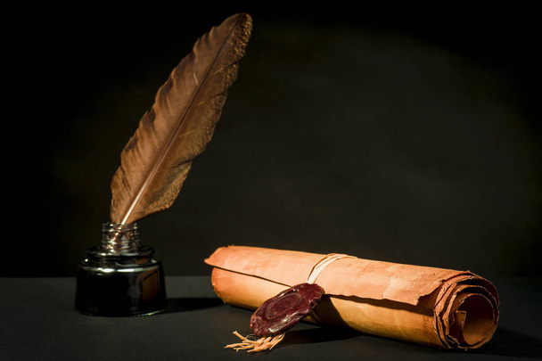 Scroll of a papyrus with a seal, a feather and an inkwell - Foto, afbeelding