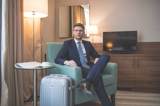 Young businessman in a suit in room - Fotó, kép
