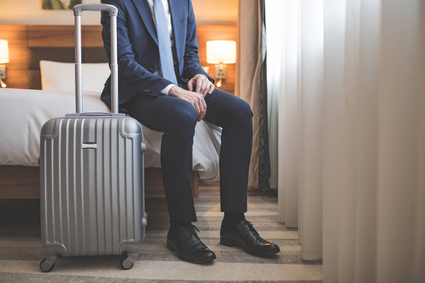 Young businessman in suit with a suitcase - Photo, Image