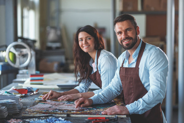 Smiling people with a mosaic in workshop - Photo, Image