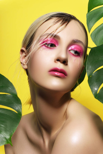 beautiful girl pink shine makeup yellow background - Fotó, kép