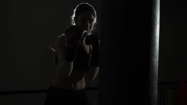 Female boxer training at the boxing club - Felvétel, videó