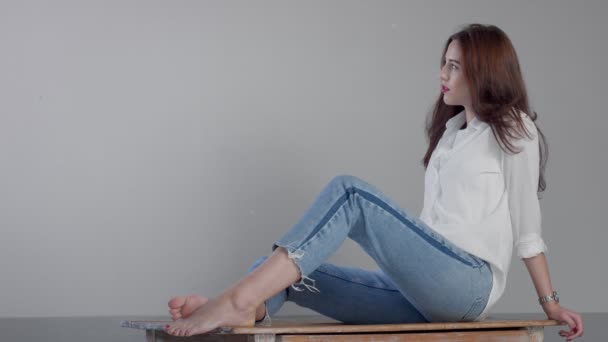woman in industrial studio wears jeans and white shirt - Footage, Video