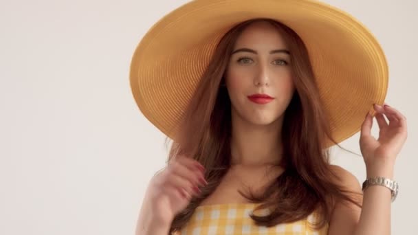 closeup portrait of woman with large straight hair wears big summer yelow hat - Video
