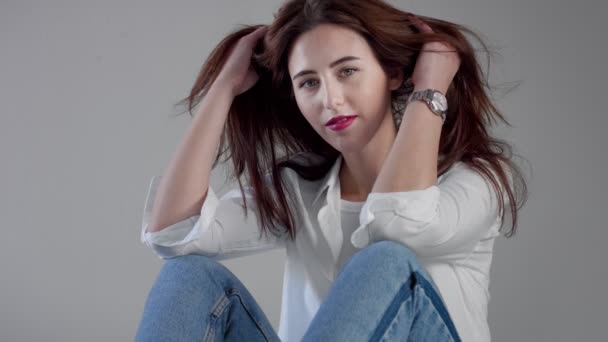 woman in industrial studio wears jeans and white shirt - Video