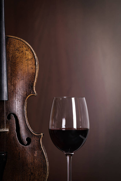 Violin waist detail with glass of wine - Photo, image