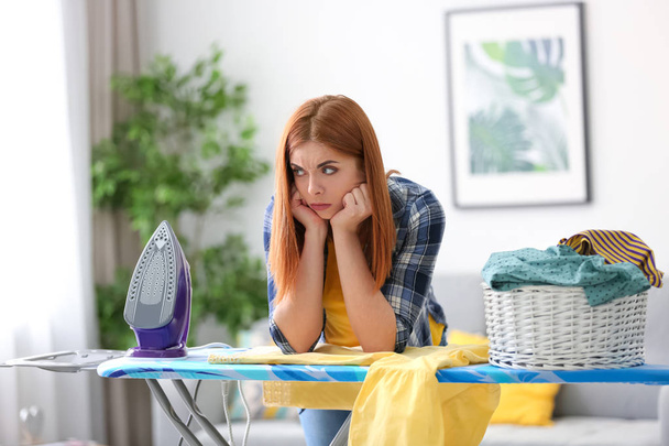 Tired housewife ironing clothes at home - Foto, immagini