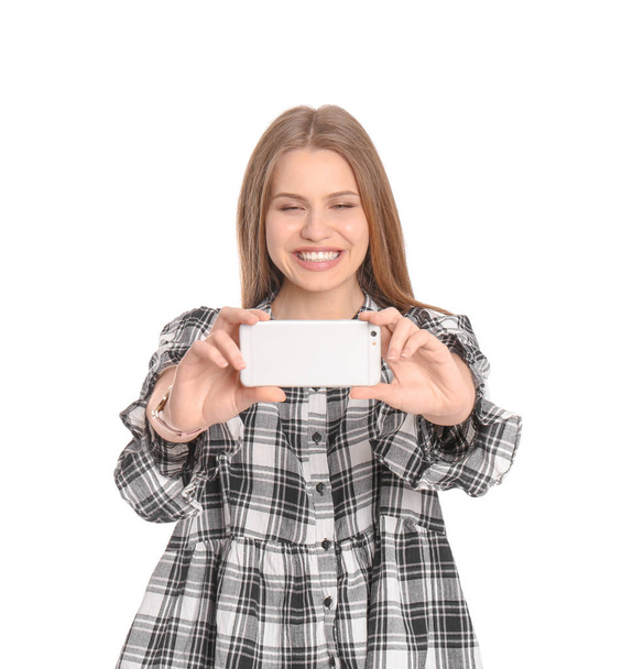 Young beautiful woman taking selfie against white background - Zdjęcie, obraz
