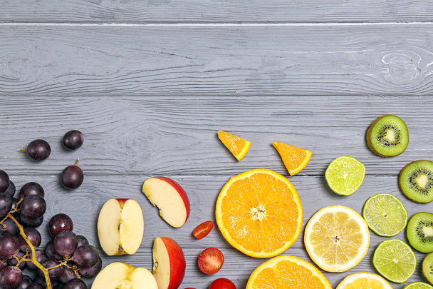 Rainbow composition with fresh fruits on wooden background, flat lay - Fotografie, Obrázek